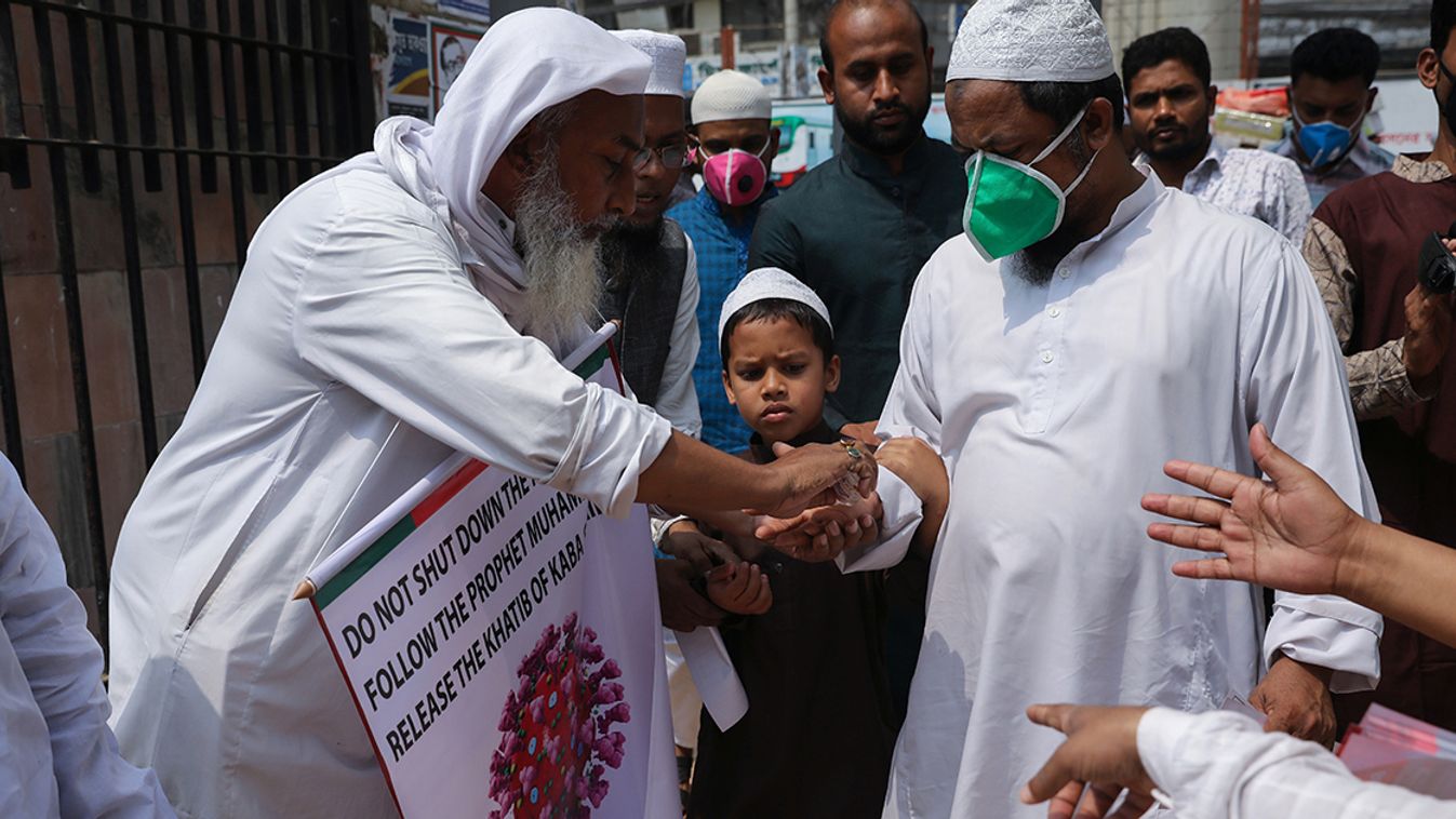 Muslims apply hand sanitizers before entering inside the Baitul Mokarram National Mosque to attend Friday prayer amid concerns about the spread of coronavirus disease (COVID-19) in Dhaka