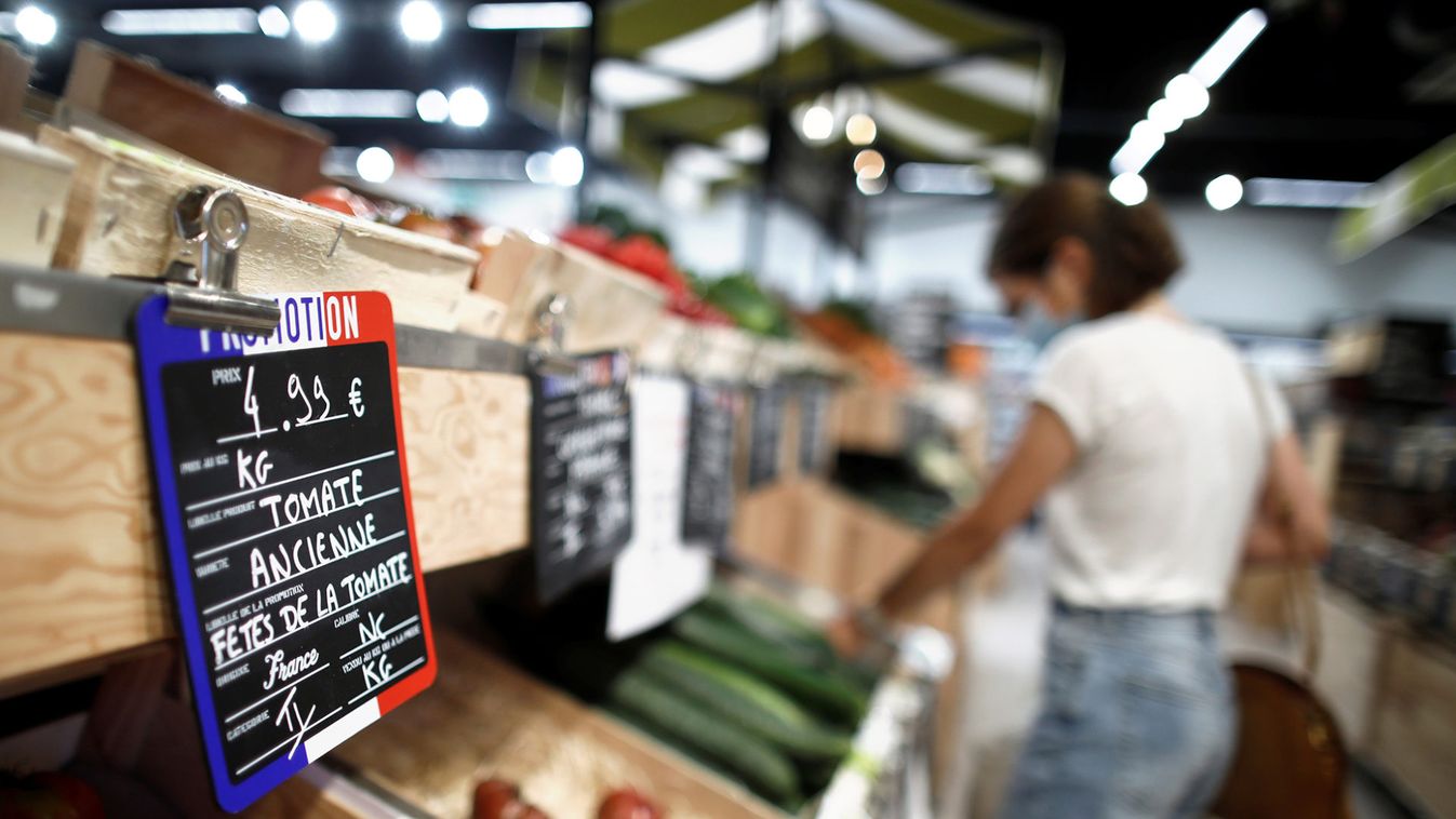 A customer shops for vegetables at a Naturalia organic foods grocery store operated by Casino Group, in Bretigny-sur-Orge