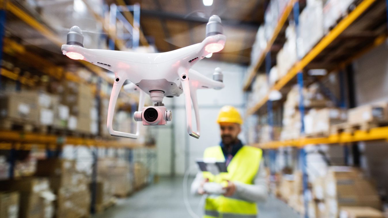 Man with drone in a warehouse.