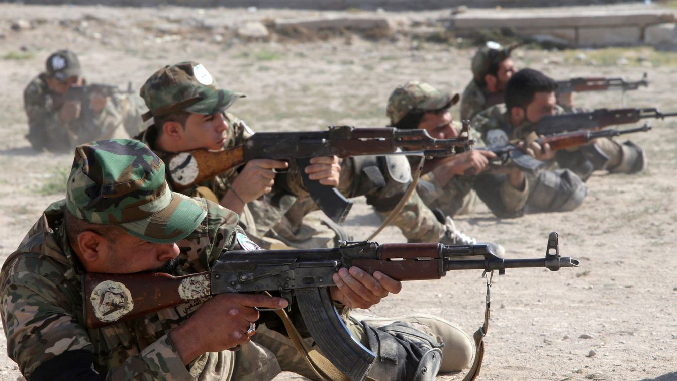 Members of the paramilitary Popular Mobilisation Forces (PMF) take part in a weapons training at their camp in Basra