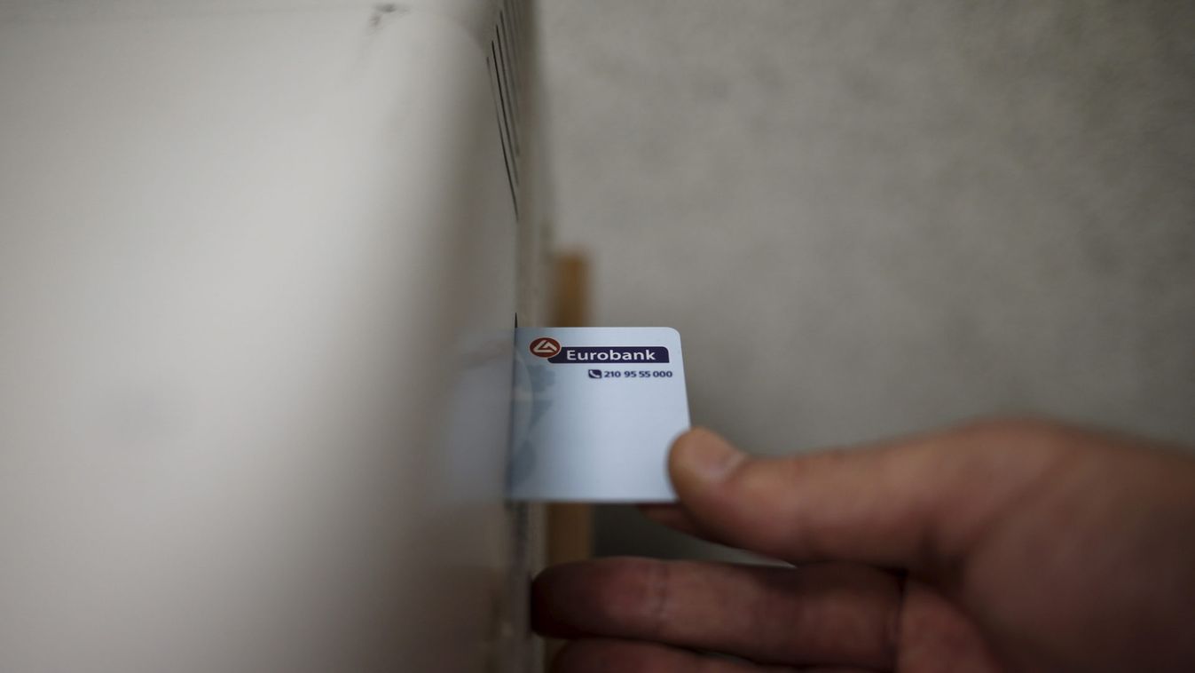 A Eurobank employee prepares to issue a credit card at a bank's branch in central Athens