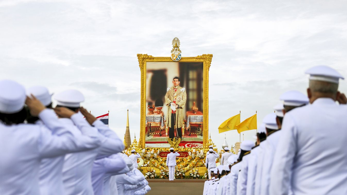 Thai officials pay respect next to a picture of Thailand's King Maha Vajiralongkorn outside the Grand Palace in Bangkok
