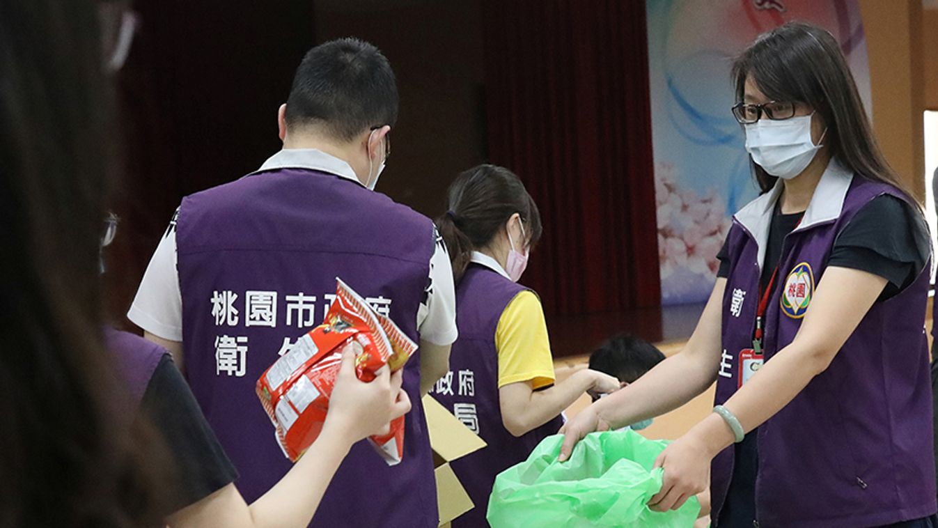 Taoyuan health department staffers pack 300 sets of care packages, to be delivered to people who have been ordered to be under self-quarantine, in Taoyuan