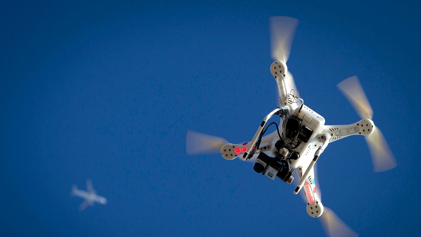 Airplane flies over a drone during the Polar Bear Plunge on Coney Island in the Brooklyn borough of New York