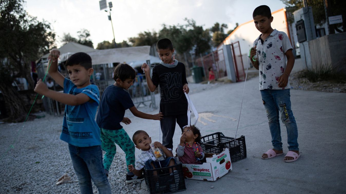 Children play at a makeshift camp for refugees and migrants next to Moria camp on the island of Lesbos