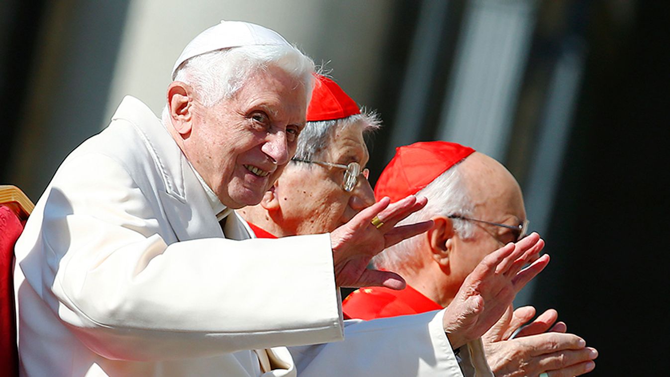 Emeritus Pope Benedict XVI waves before a mass in Saint Peter's square at the Vatican