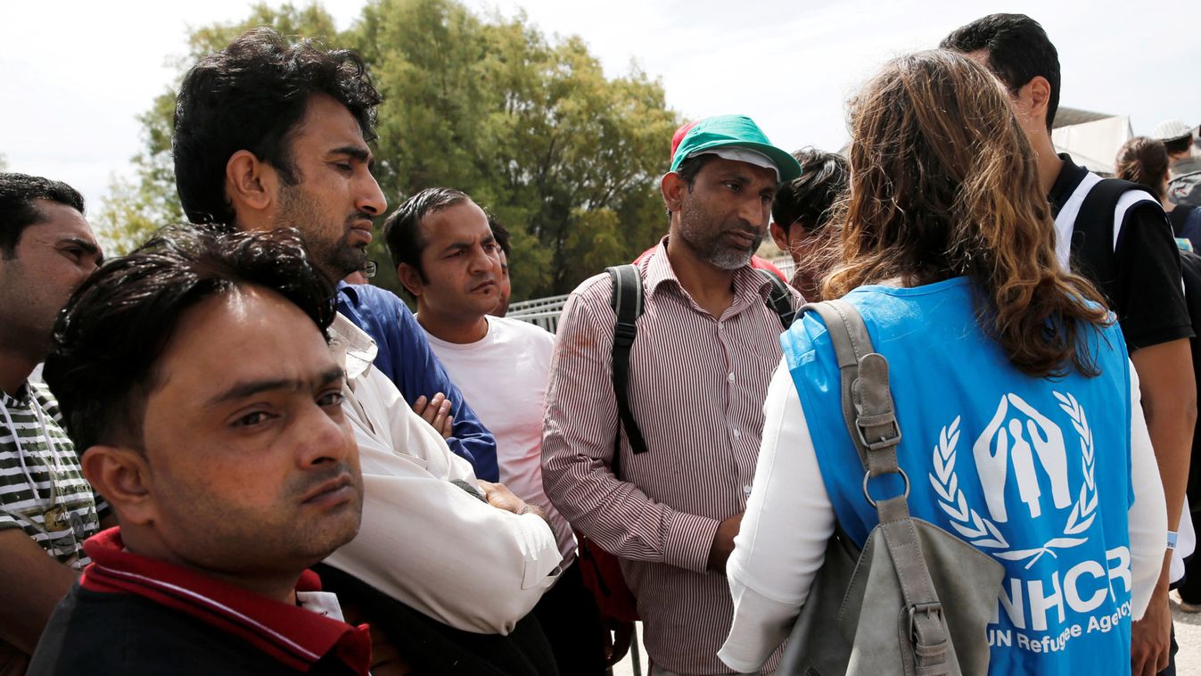 Refugees and migrants are briefed by a UNHCR staff before a pre-registration process that gives them access to the asylum procedure, at the premises of the disused Hellenikon airport, in Athens