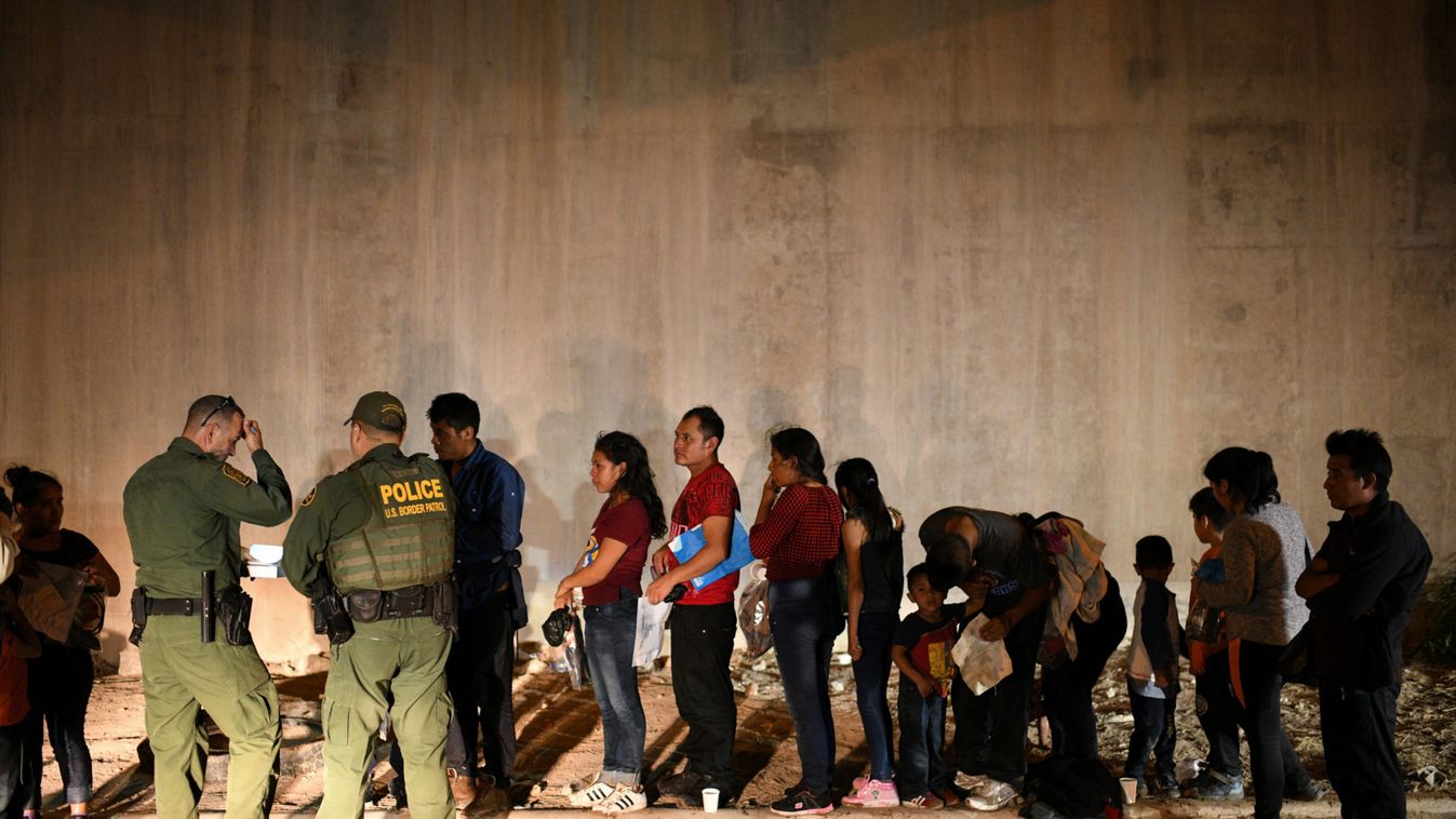 Migrant families turn themselves to U.S. Border Patrol to seek asylum following an illegal crossing of the Rio Grande in Hidalgo