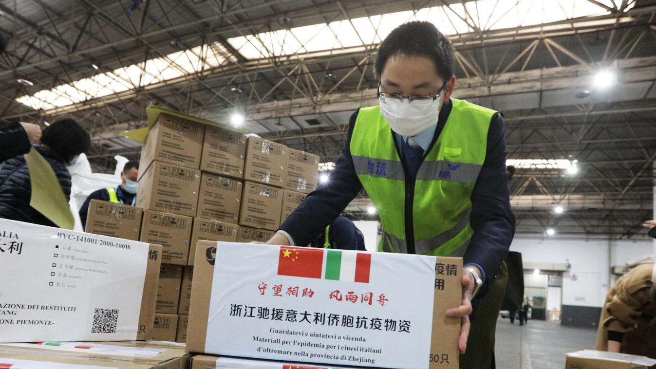 Staff members move medical supplies to be sent to Italy for the prevention of the novel coronavirus, following the coronavirus outbreak, at a logistics center of the international airport in Hangzhou, Zhejiang