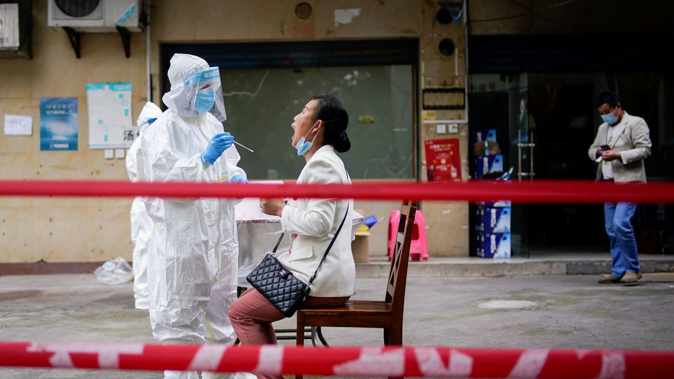 A medical worker in protective suit conducts nucleic acid testings for residents at a residential compound in Wuhan