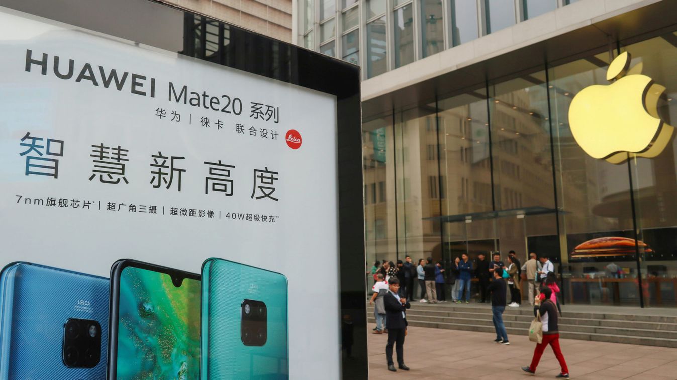 Advertisement for Huawei Mate 20 series is seen outside an Apple store, as customers queue before the store opens on the day the new iPhone XR goes on sale in Shanghai