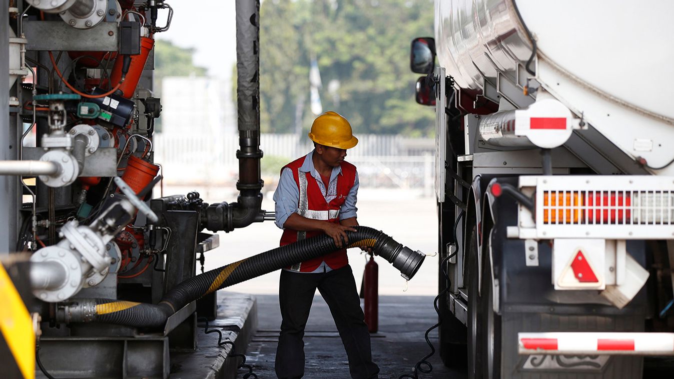 A worker fills a tanker truck with fuel at a state-owned Pertamina fuel depot in Jakarta