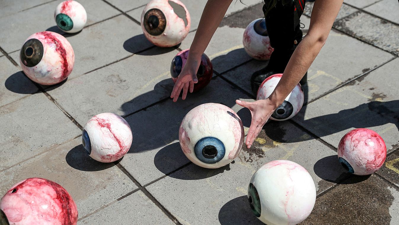 An activist places eye models as support to victims of ocular trauma during recent protests against Chile's government, ahead of the upcoming referendum on a new Chilean constitution in Santiago