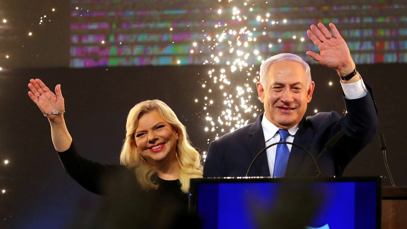 Israeli Prime Minister Benjamin Netanyahu and his wife Sara wave as Netanyahu speaks following the announcement of exit polls in Israel's parliamentary election at the party headquarters in Tel Aviv, Israel