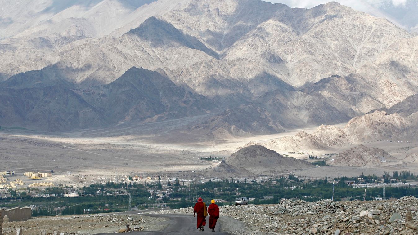 Buddhist monks walk on road in Stok north of Leh