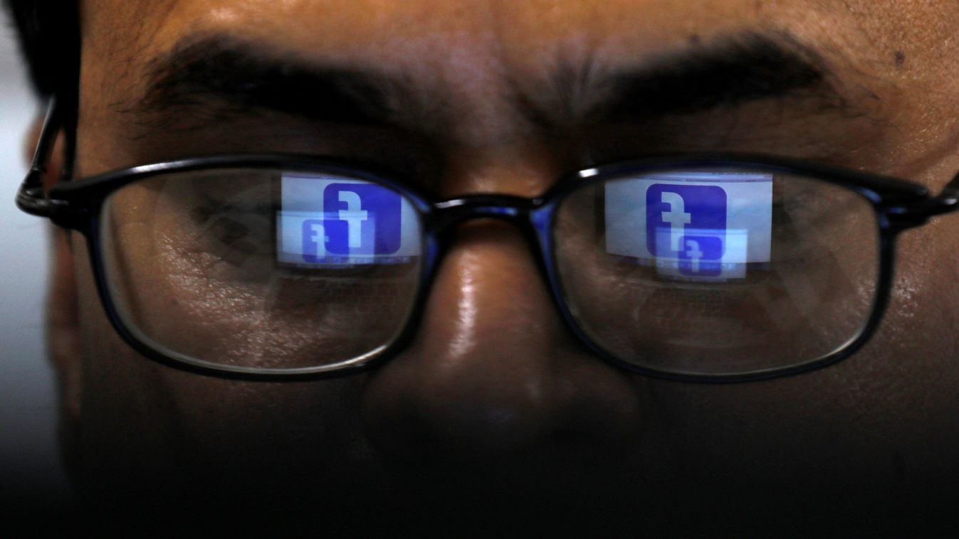 Facebook logo is reflected in glasses in this picture illustration