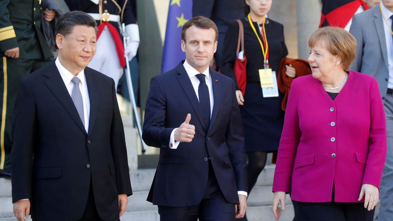 French President Emmanuel Macron, German Chancellor Angela Merkel and Chinese President Xi Jinping leave following a meeting at the Elysee Palace in Paris