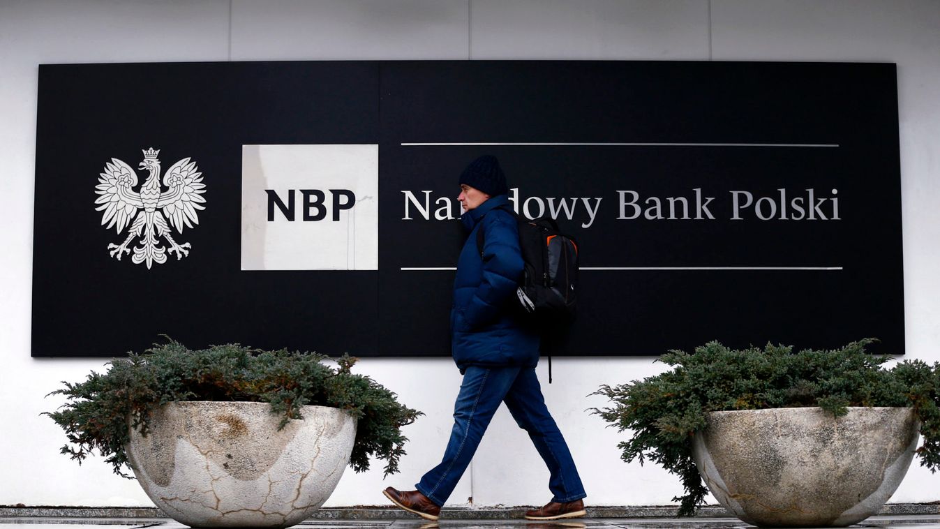A man walks in front of the National Bank of Poland headquarters in Warsaw