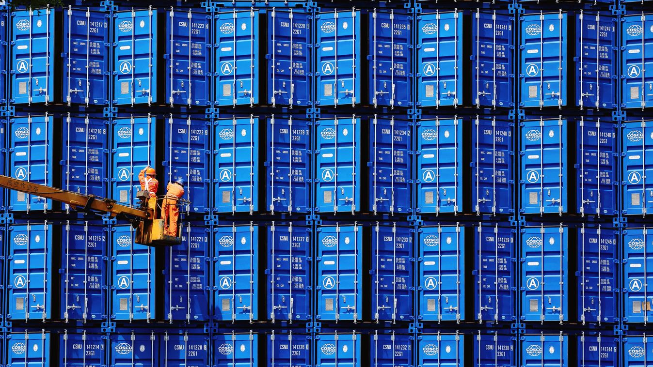 Workers inspect COSCO shipping containers at a container manufacturer in Jinzhou