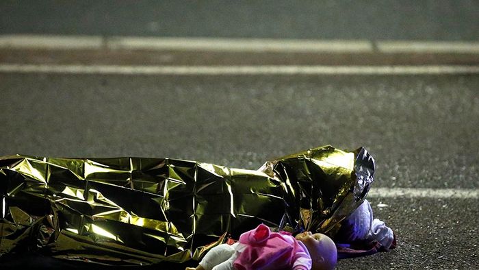 A body is seen on the ground after at least 30 people were killed in the southern French town of Nice when a truck ran into a crowd celebrating the Bastille Day national holiday