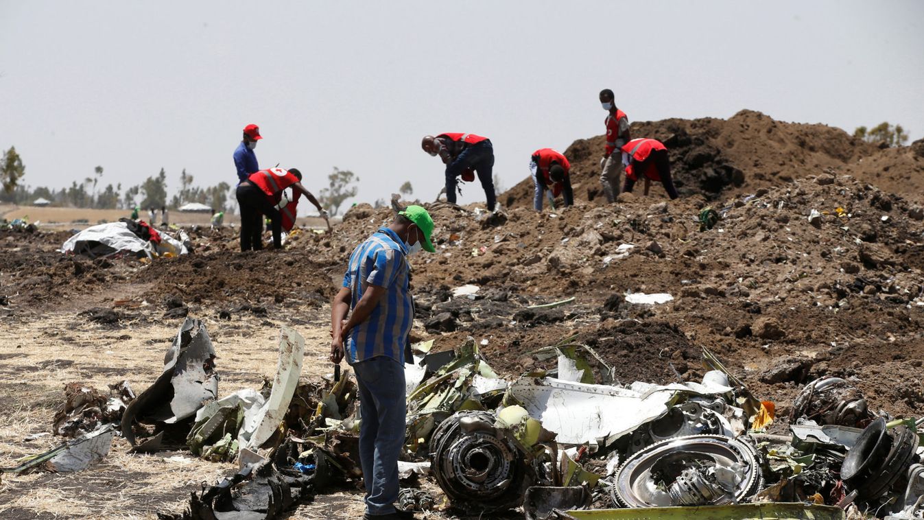 A man watches debris at the scene of the Ethiopian Airlines Flight ET 302 plane crash, near the town of Bishoftu, southeast of Addis Ababa
