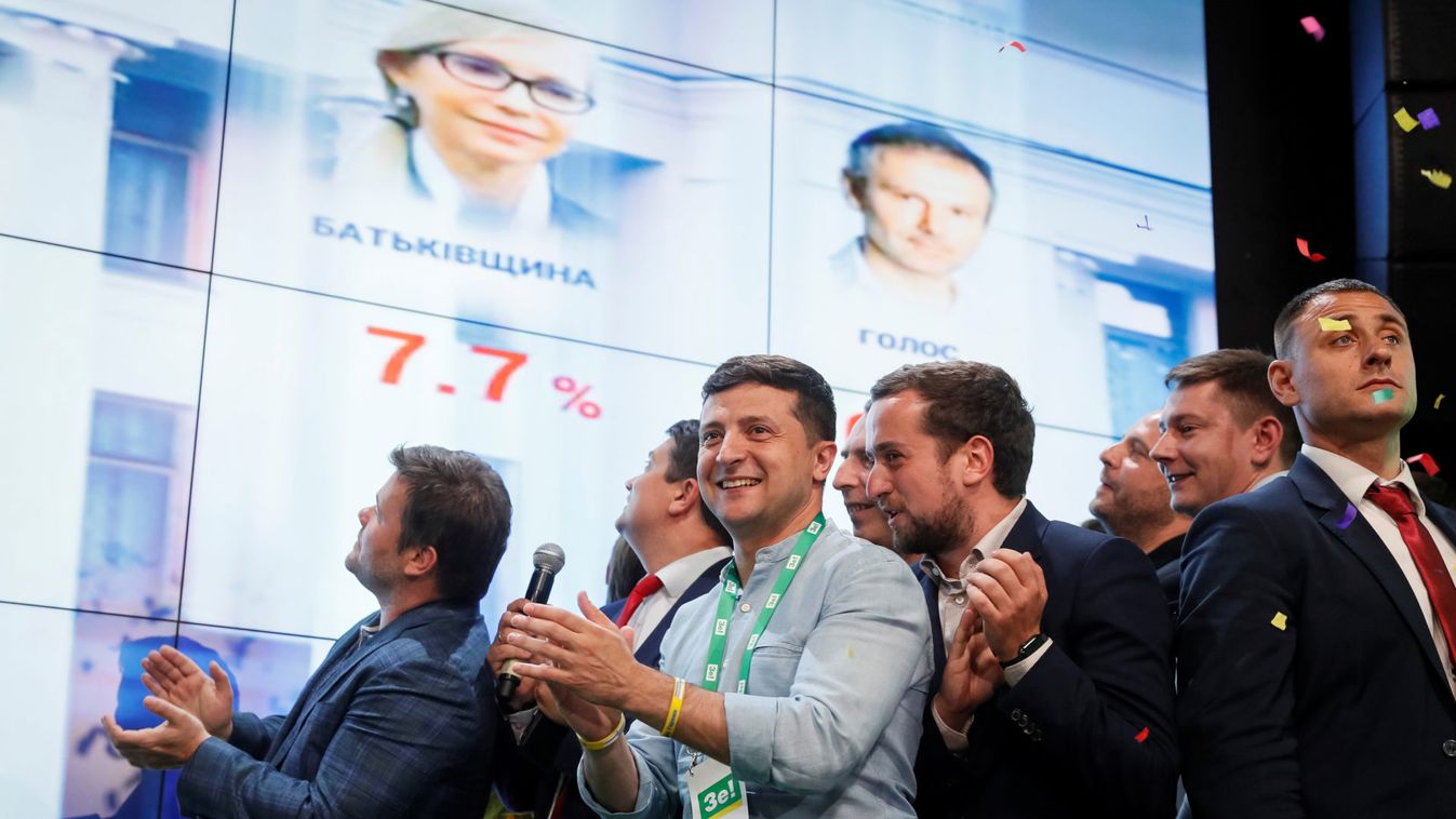 Ukraine's President Volodymyr Zelenskiy reacts at his party's headquarters after a parliamentary election in Kiev