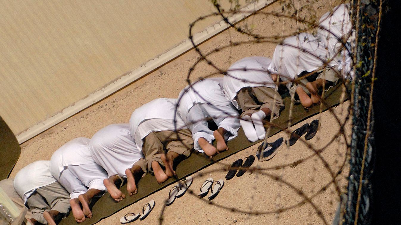 File photo of detainees observing morning prayer before sunrise inside Camp Delta at Guantanamo Bay naval base
