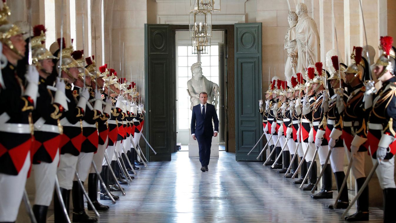 French President Emmanuel Macron walks through the Galerie des Bustes before his address to the upper and lower houses of the French parliament at a special session in Versailles near Paris