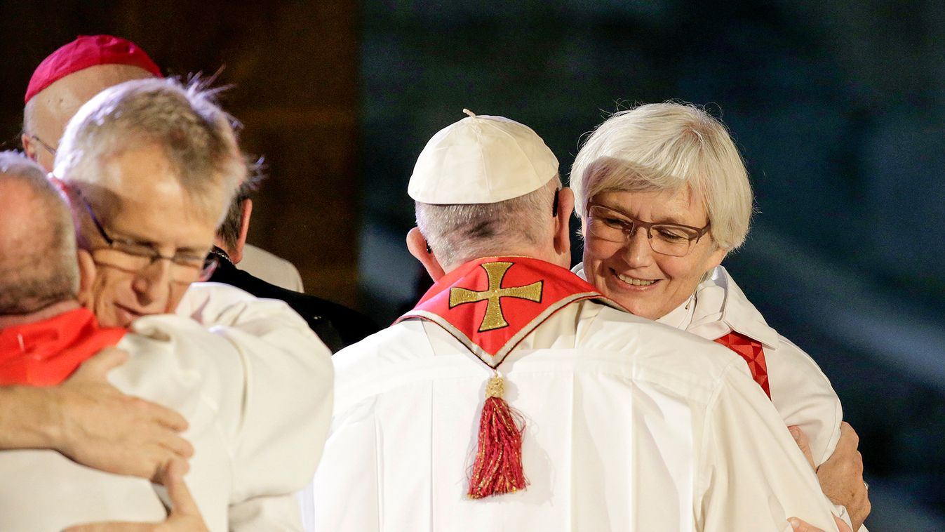 Pope Francis embraces Lutheran Archbishop of Uppsala Antje Jackelen during a ecumenical mass in the cathedral  in Lund