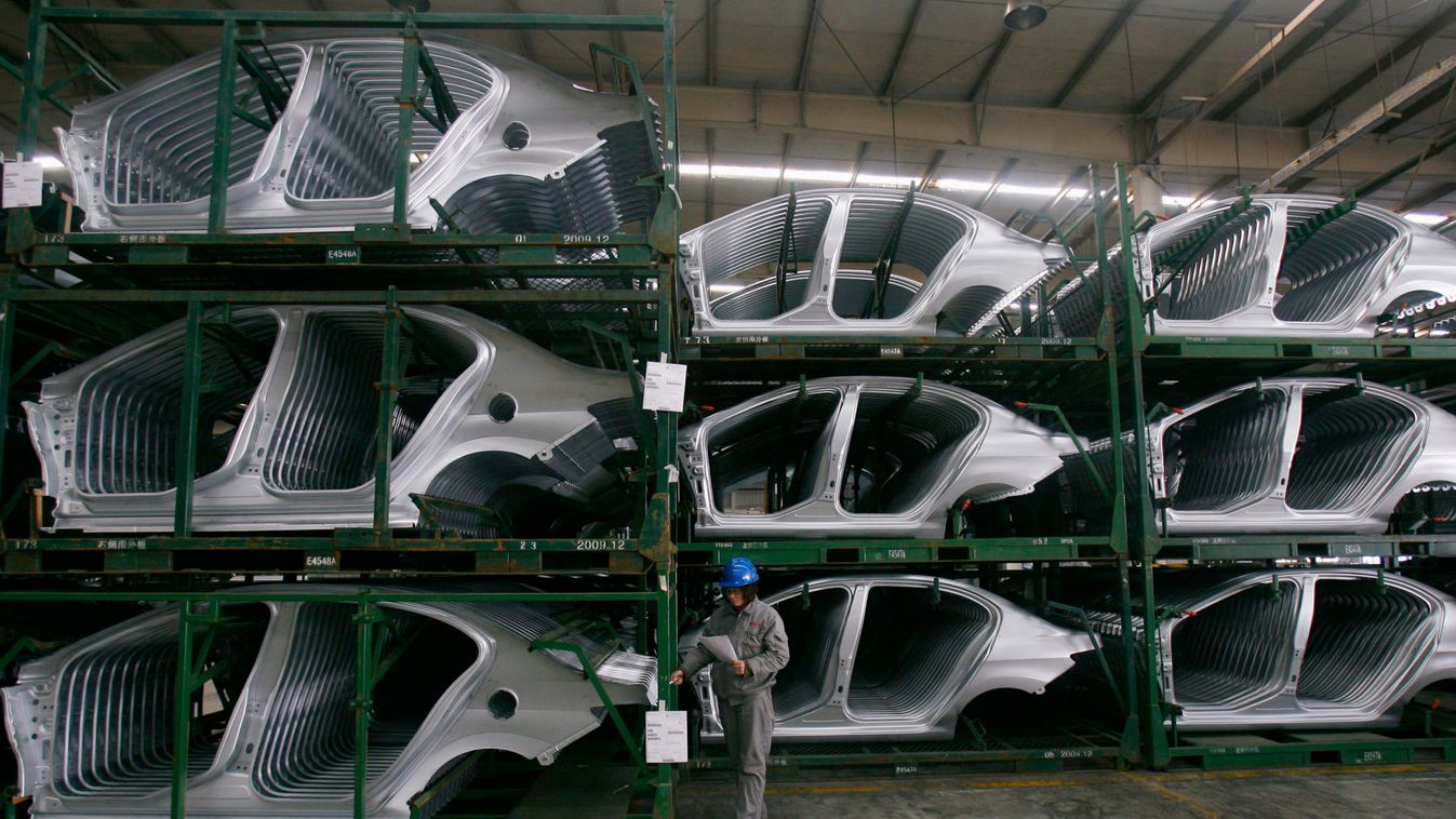 An employee checks Citroen C5 car components at a factory in Wuhan