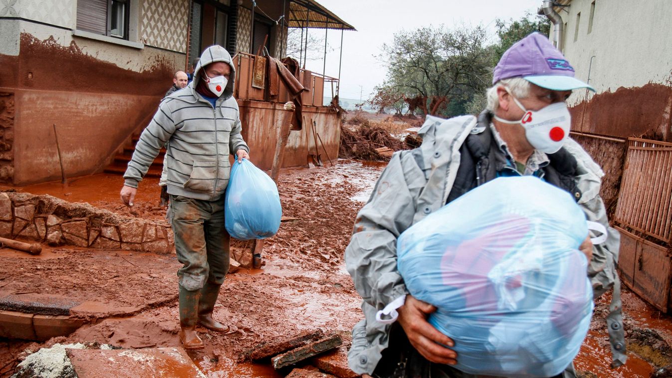 Residents leave their home in the flooded village of Devecser
