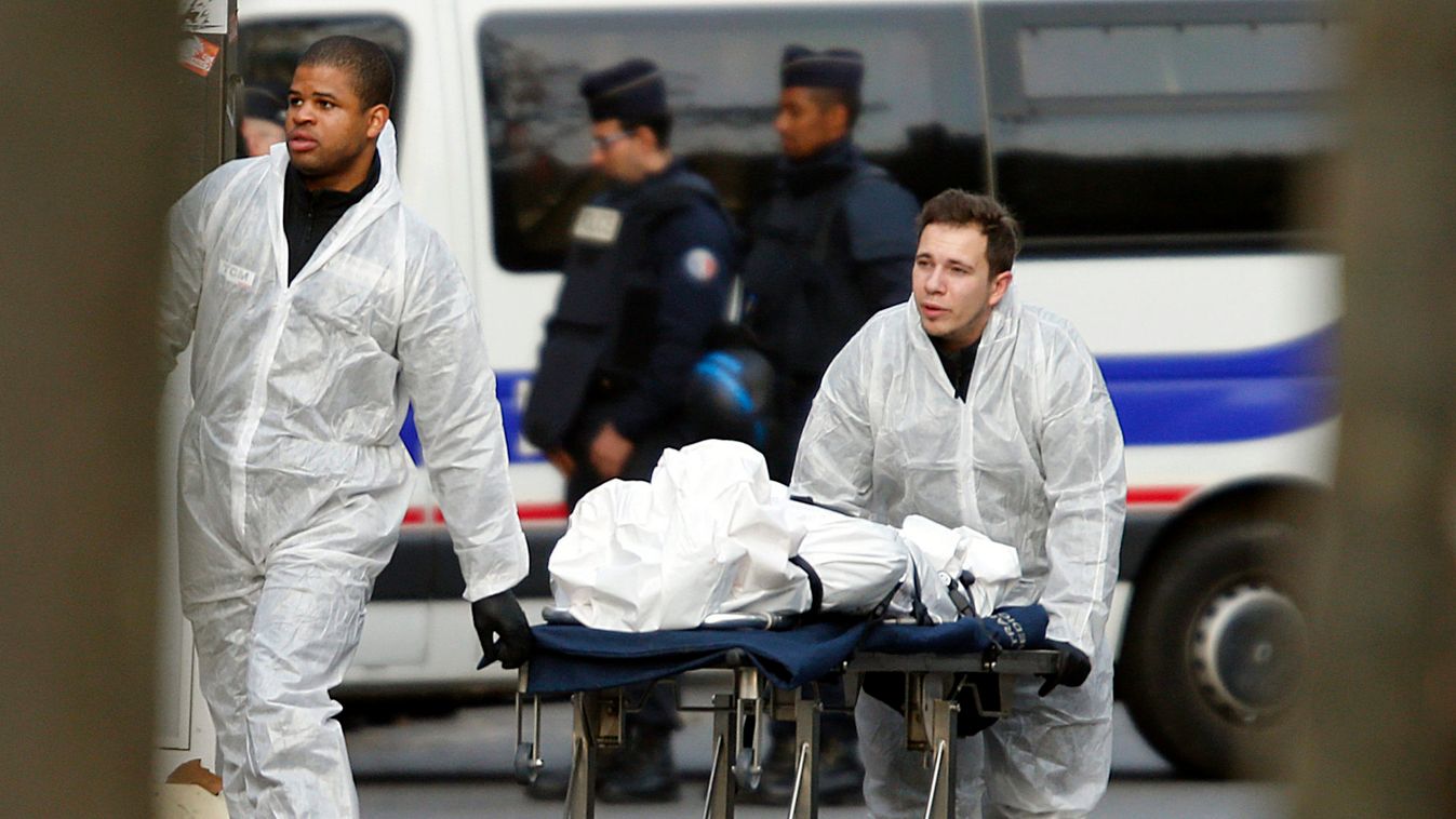 A victim is wheeled out of the Bataclan concert hall the morning after a series of deadly attacks in Paris