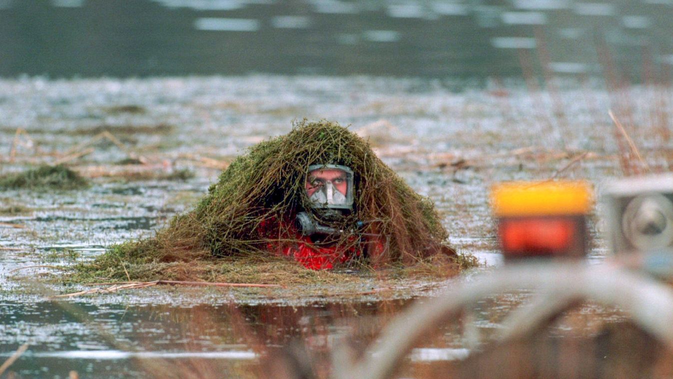 A Swedish police diver searches in vain for a suspected murder weapon in the Alby Lake, south of Sto..