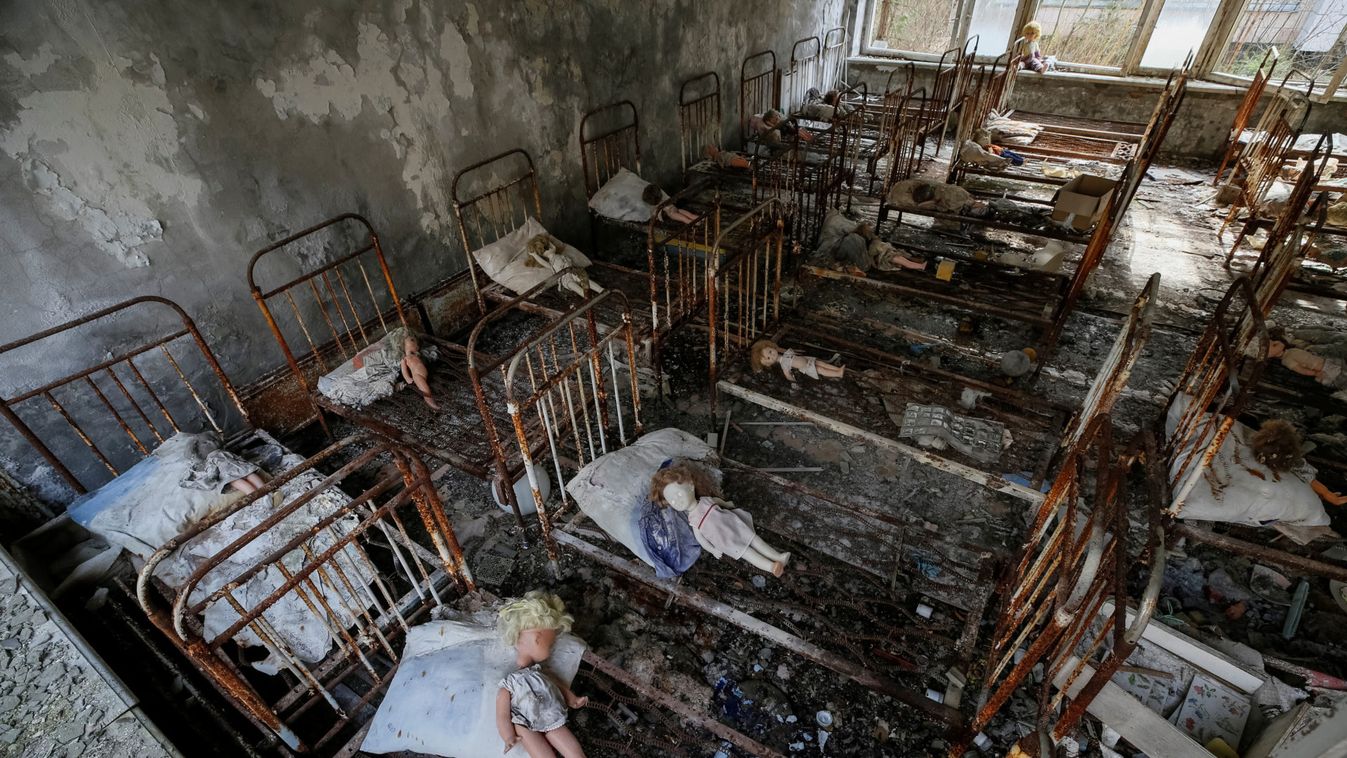 Dolls, which were placed by a visitor, lie at beds at a kindergarten in the abandoned city of Pripyat near the Chernobyl nuclear power plant in Ukraine