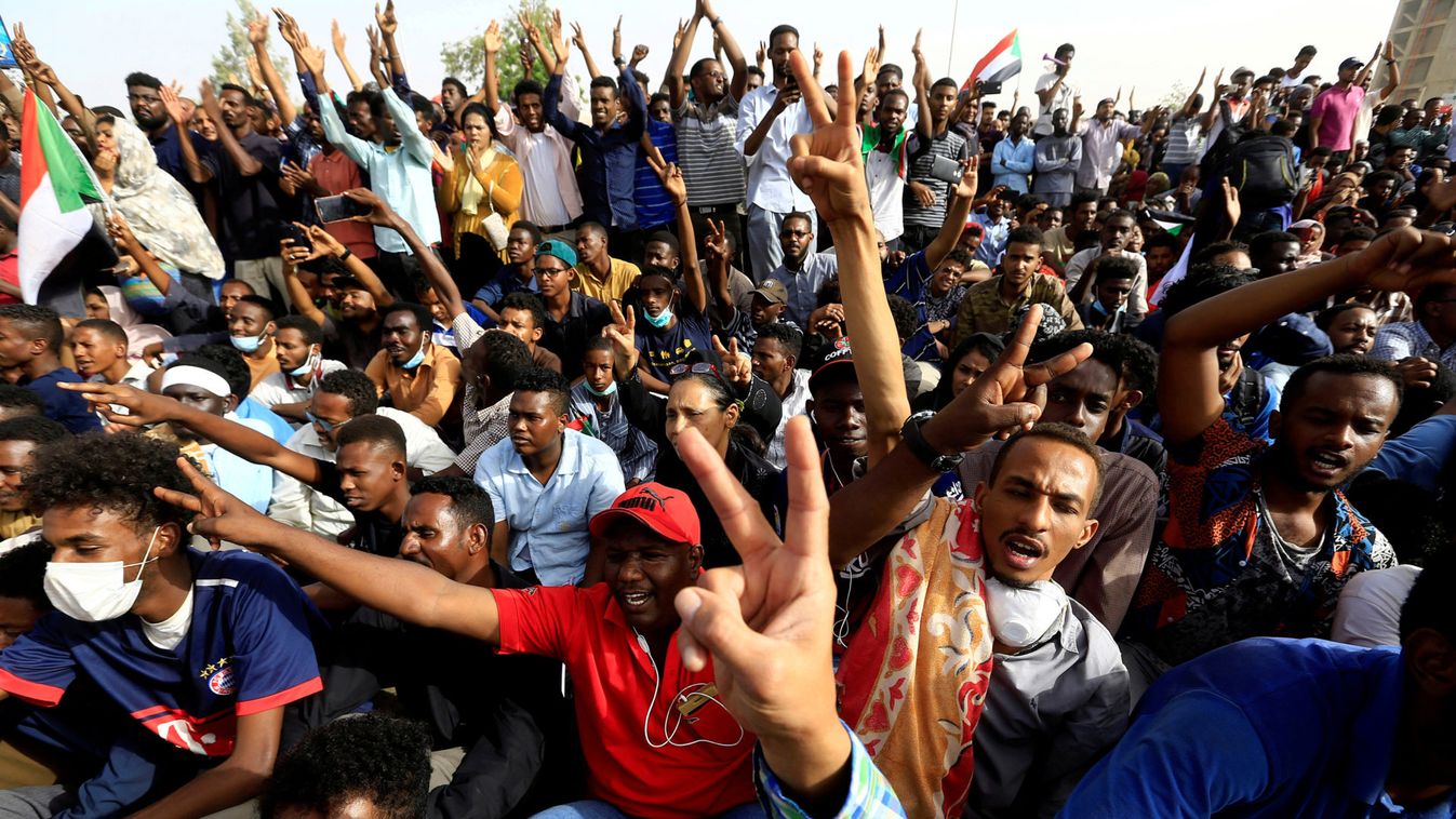 Sudanese demonstrators cheer as they attend a protest rally demanding Sudanese President Omar Al-Bashir to step down outside the Defence Ministry in Khartoum