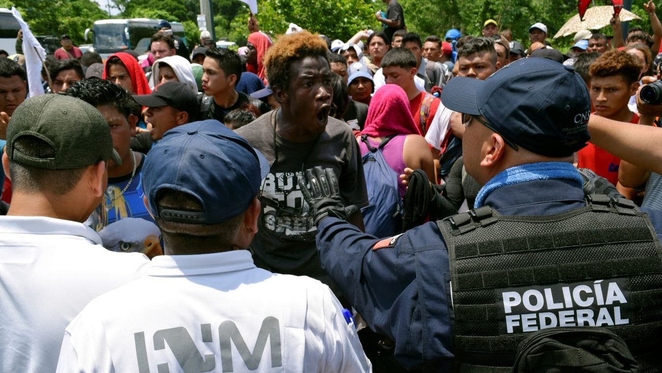 A migrant argues with a federal police officer during a joint operation by the Mexican government to stop a caravan of Central American migrants on their way to the U.S., at Metapa de Dominguez