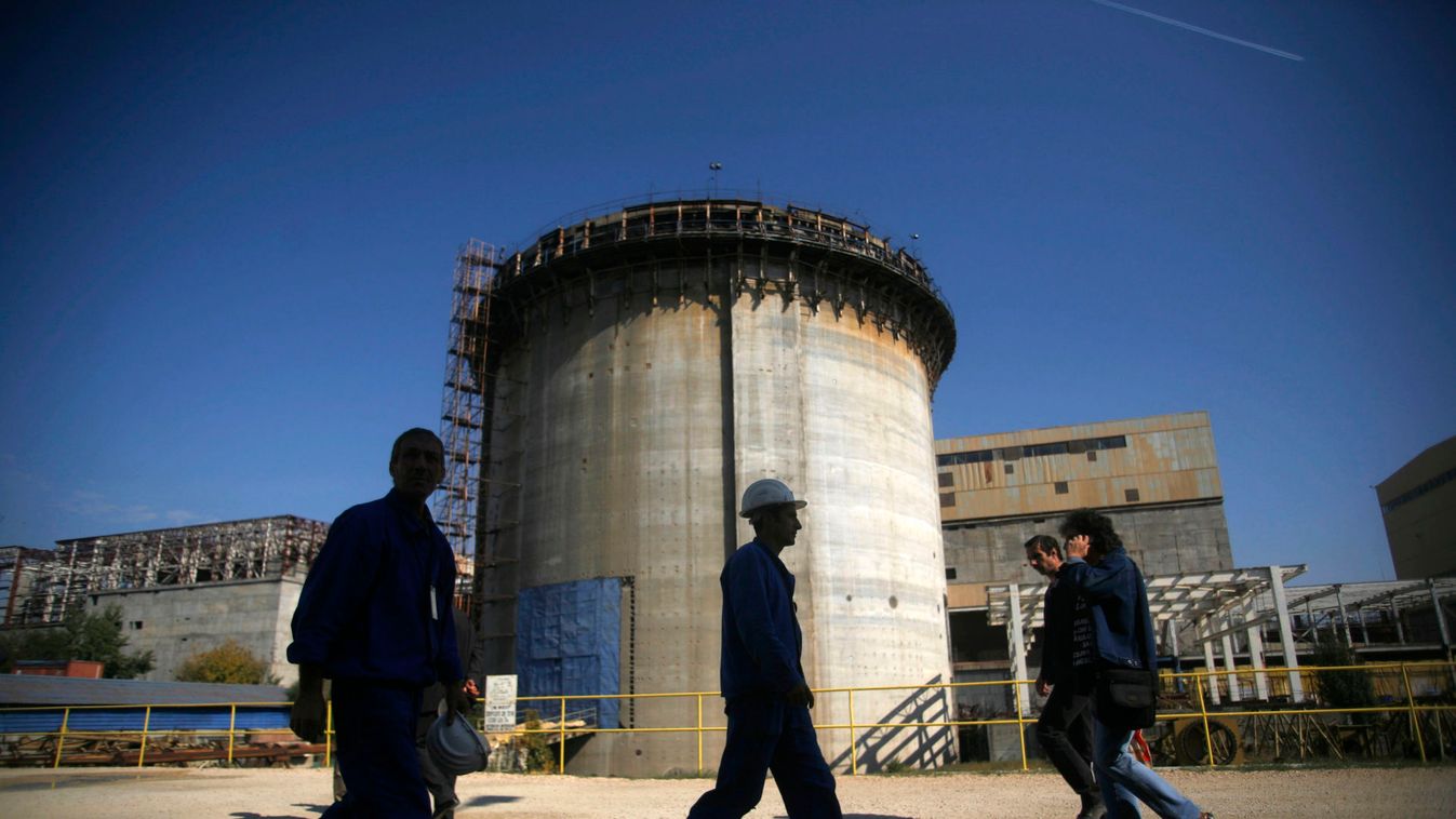 People pass by an inactive unit of the nuclear power plant in Cernavoda