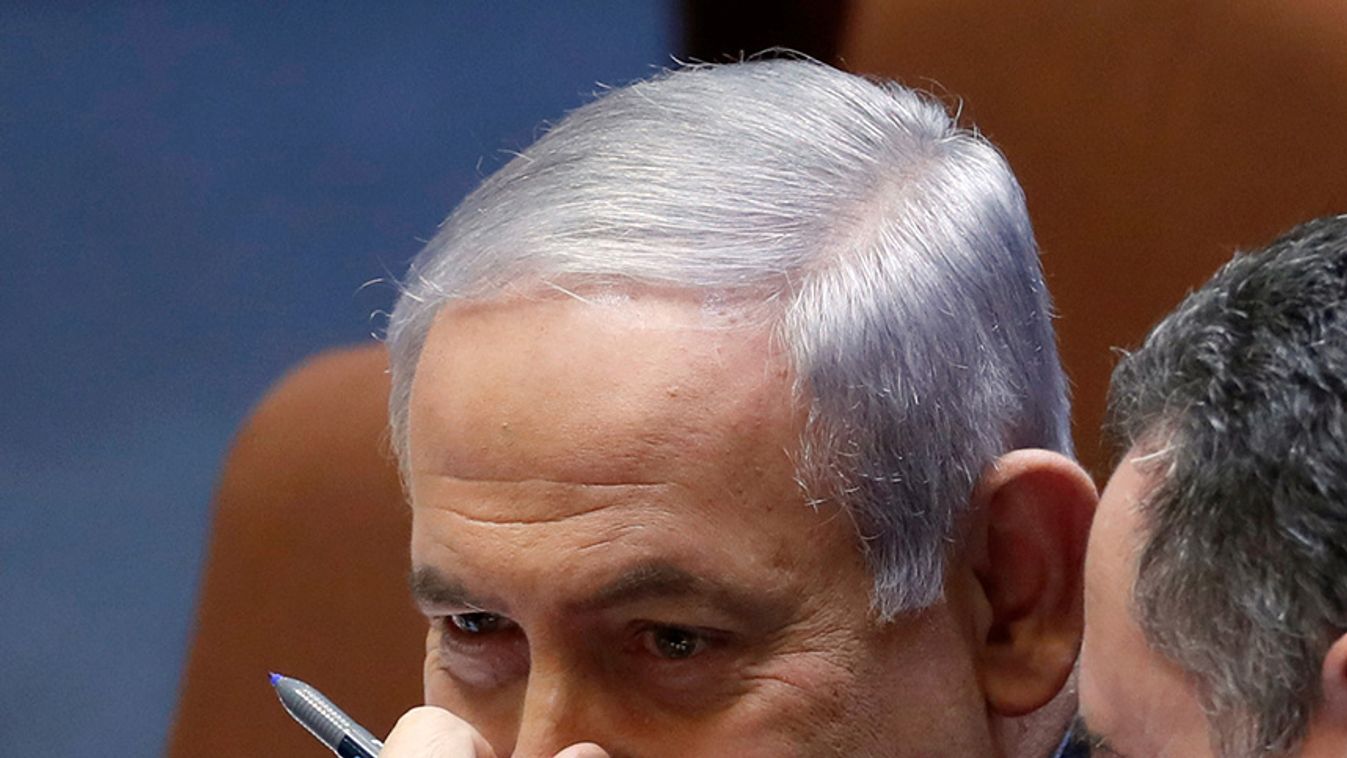 Israeli Prime Minister Benjamin Netanyahu speaks with Minister of Transportation Israel Katz at the plenum at the Knesset, Israel's parliament, in Jerusalem