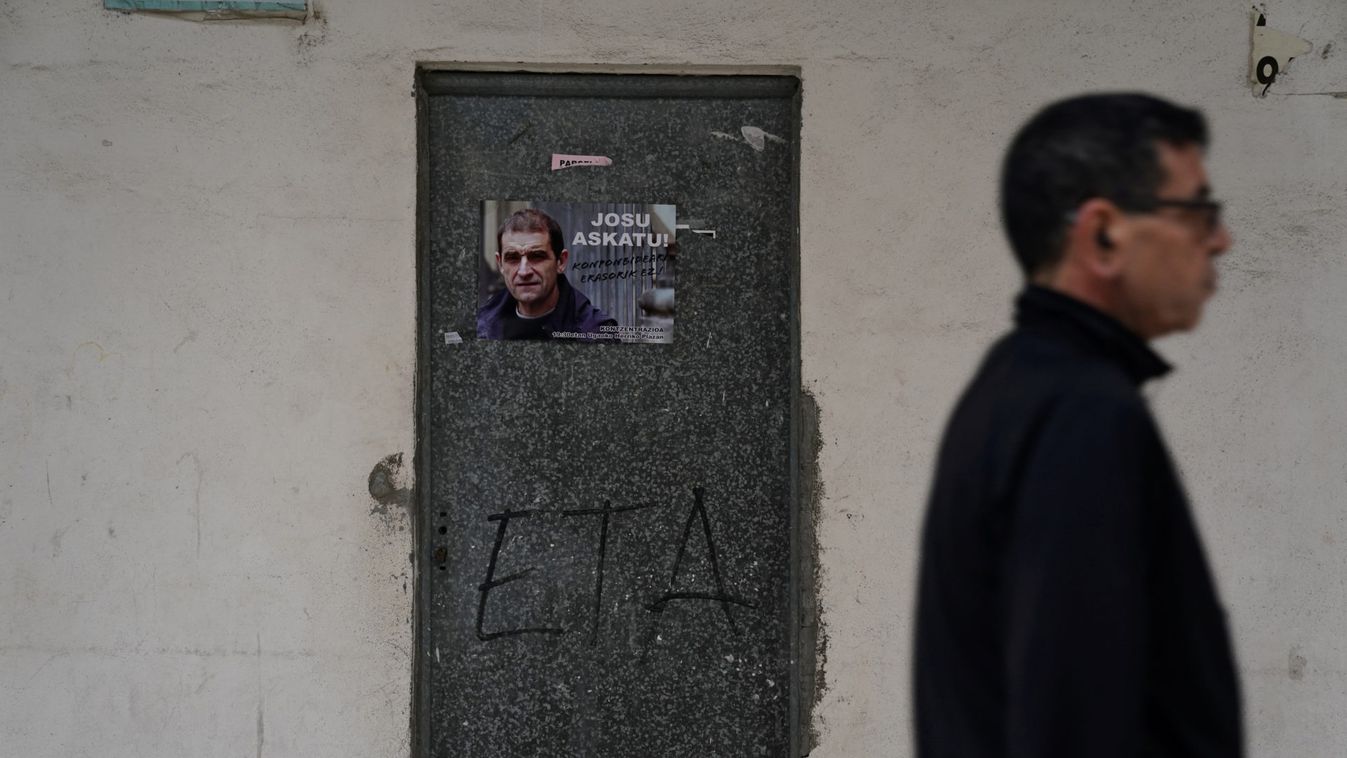 A man walks past a poster of ETA leader Jose Antonio Urrutikoetxea, known as Josu Ternera, following a demonstration in his home town of Ugao-Miravalles