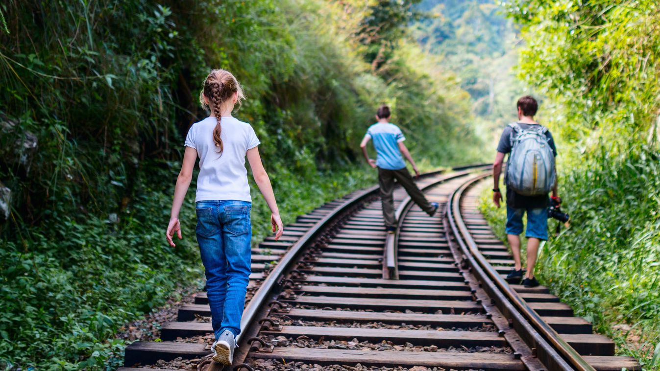 Family walking along train tracks