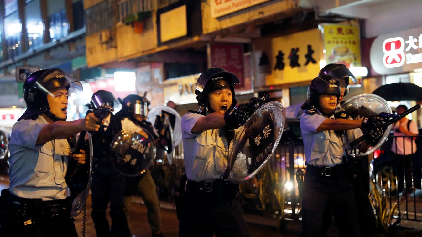 Police officers point their guns towards anti-extradition bill protesters after a clash, at Tsuen Wan, in Hong Kong