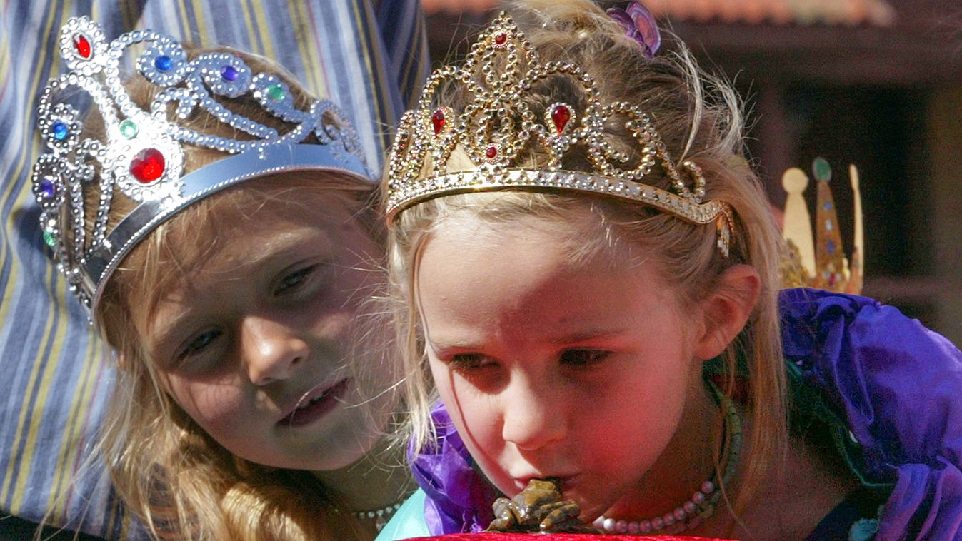 A GIRL DRESSED AS PRINCESS KISSES A PLASTIC FROG DURING THE PRINCESS
TEST IN TRONDHEIM.