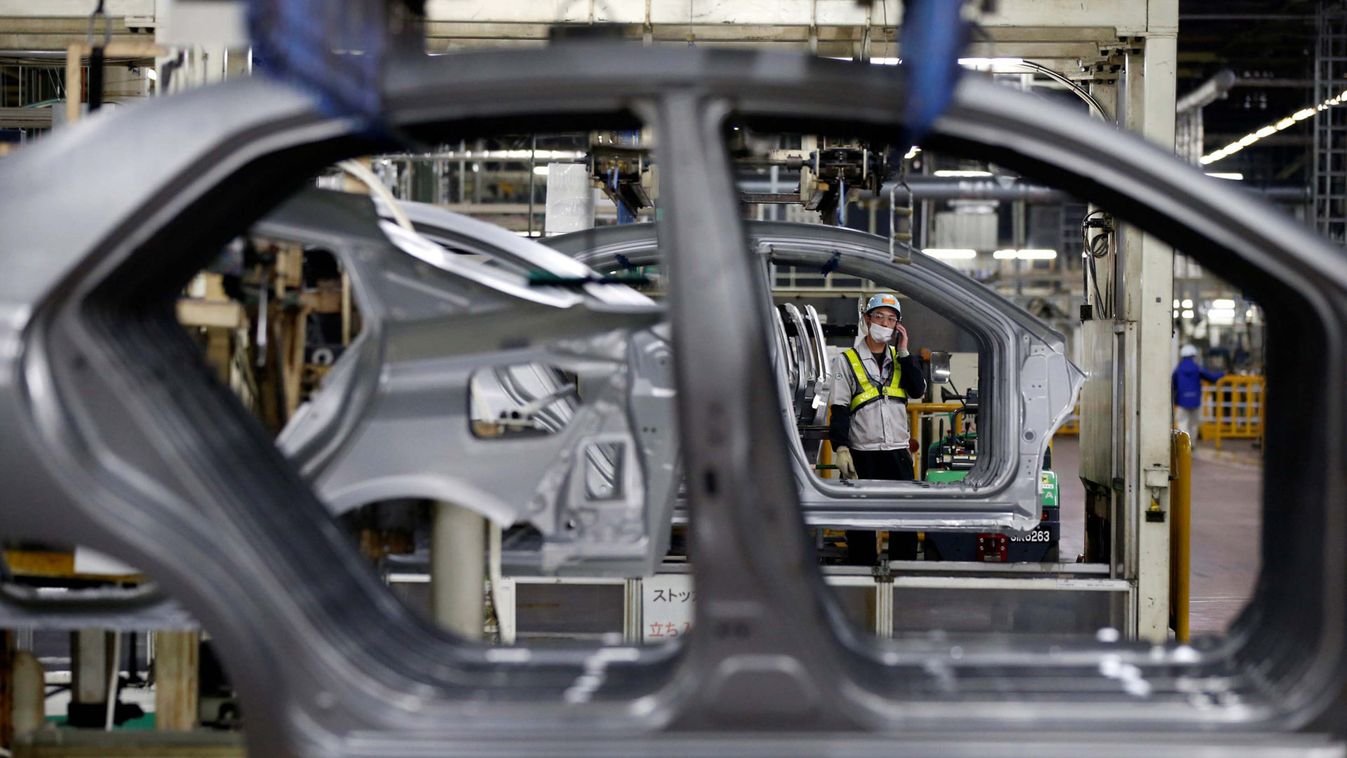An employee works on an assembly line of the Toyota Motor Corp's Prius hybrid car at the Tsutsumi plant in Toyota
