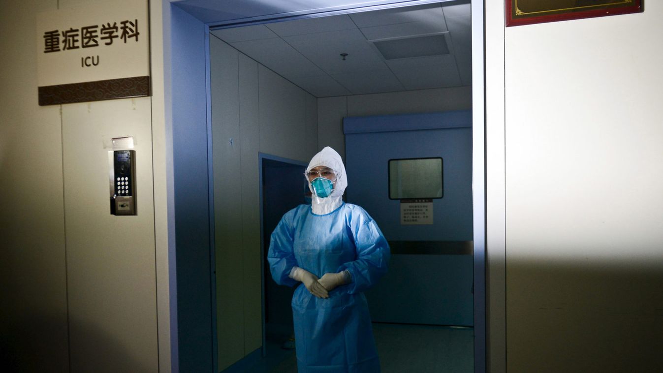 A medical personnel in a protection suit poses in front of an ICU room as she briefs the media, at a hospital where a South Korean MERS patient is being quarantined and treated, in Huizhou