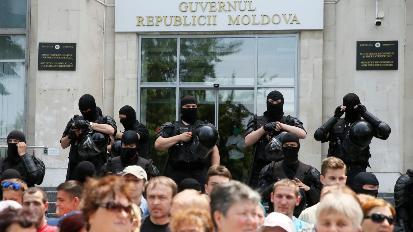 Law enforcement officers stand guard during a rally held by supporters of the Democratic Party of Moldova in Chisinau