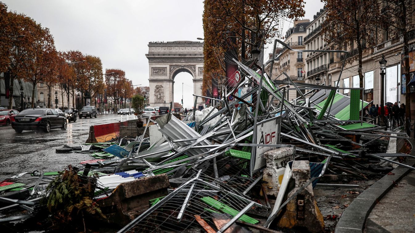 A barricade lays on the side at the Champs-Elysees avenue in the aftermath of a rally by yellow vests protesters against higher fuel prices in Paris