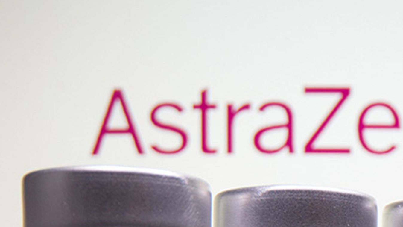 Vials and medical syringe are seen in front of AstraZeneca logo in this illustration