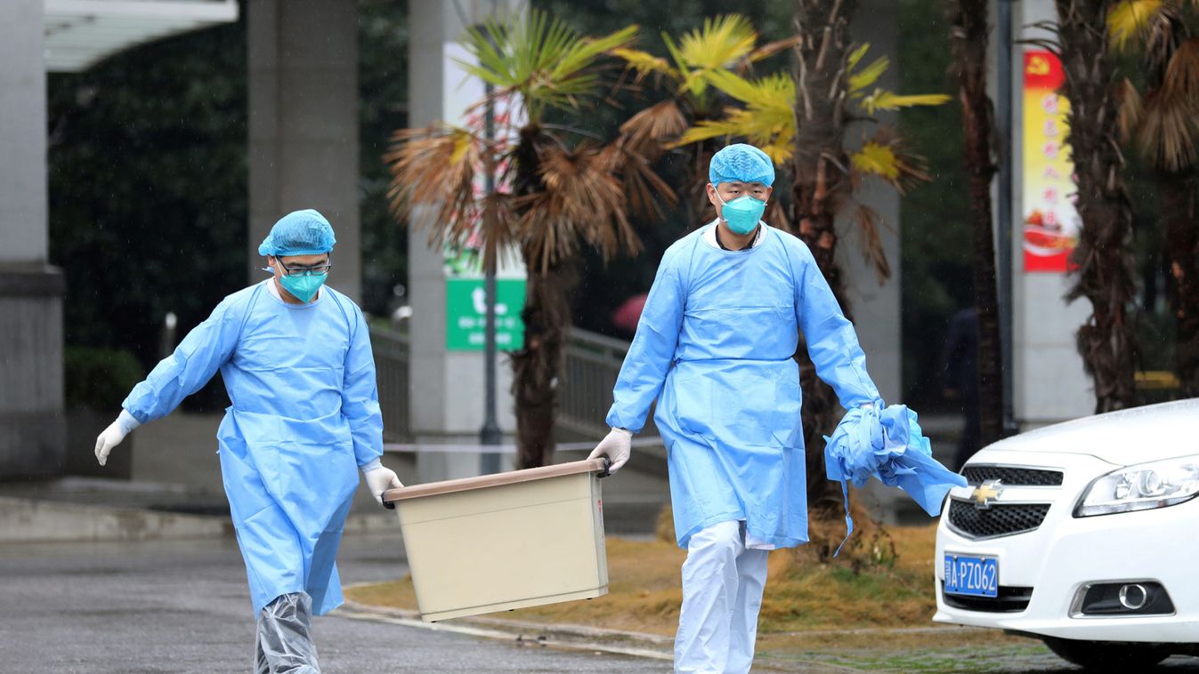 Medical staff carry a box as they walk at the Jinyintan hospital, where the patients with pneumonia caused by the new strain of coronavirus are being treated, in Wuhan