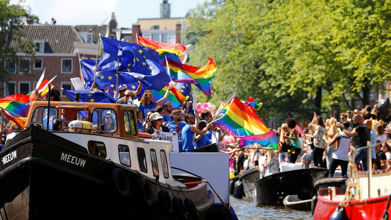 Revellers ride on the European Commission boat during the annual Canal Parade, one of the city's Gay Pride events, in Amsterdam