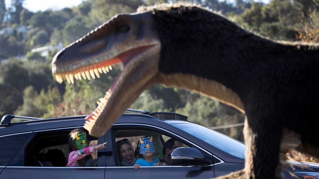 People drive through the Jurassic Quest Experience outside The Rose Bowl Stadium during the outbreak of the coronavirus disease (COVID-19), in Pasadena